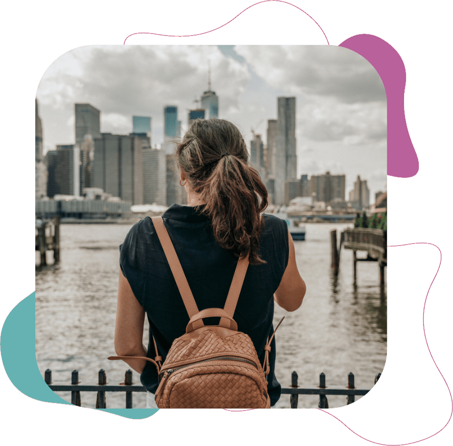 Woman looking at New York across the water from standing in New Jersey