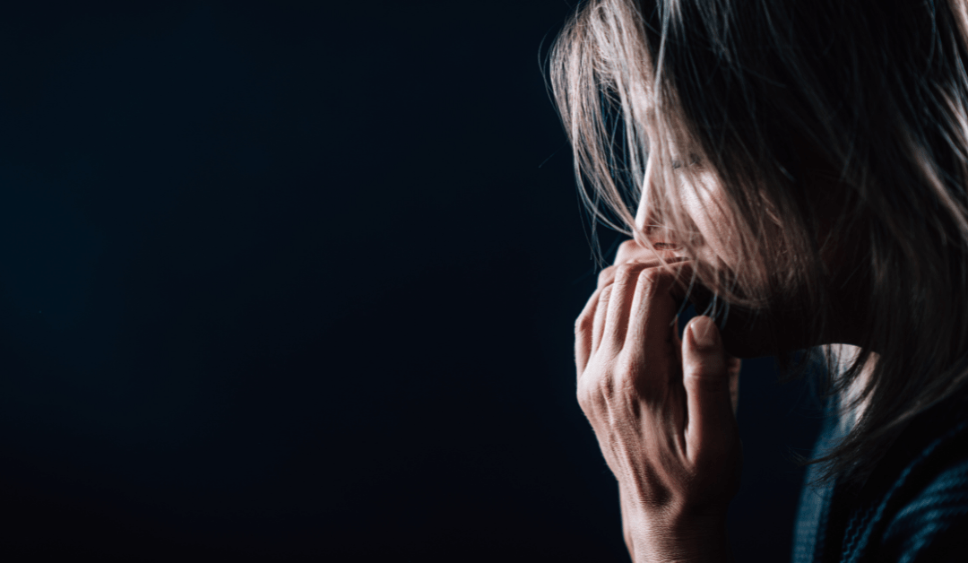 Anxious woman biting her nails