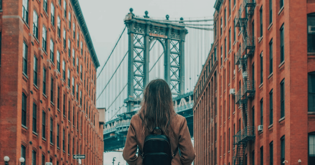 Woman looking at New York bridge after recently moving to New York City